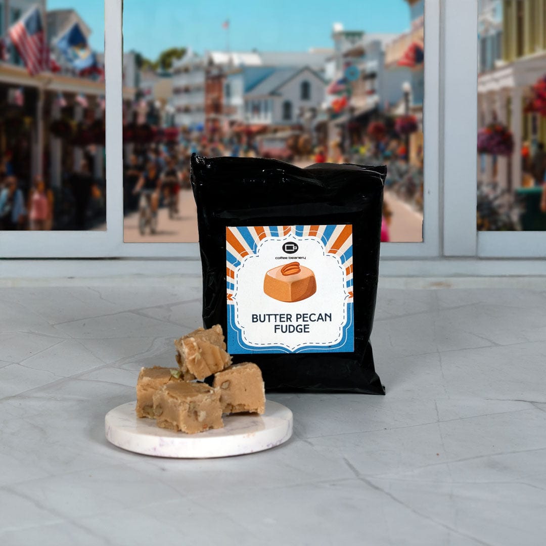 Butter pecan fudge with a black bag labeled 'Butter Pecan Fudge' on a marble surface, with a cityscape in the background.