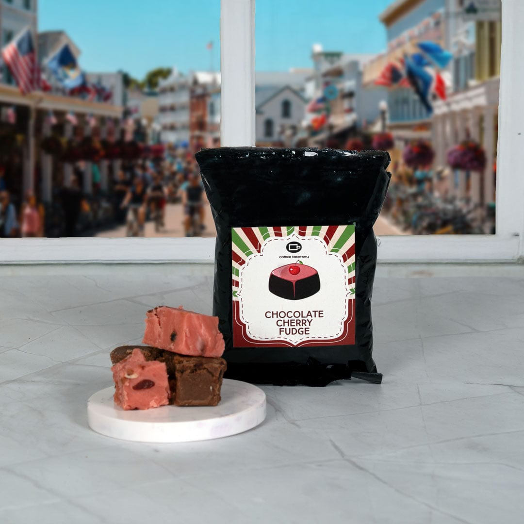 Bag of chocolate cherry fudge with fudge pieces on a marble slab, blurred city street in the background
