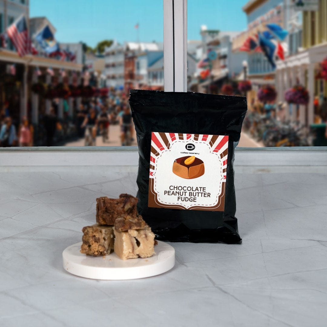 Bag of chocolate peanut butter fudge with fudge pieces on a marble slab in an outdoor setting.